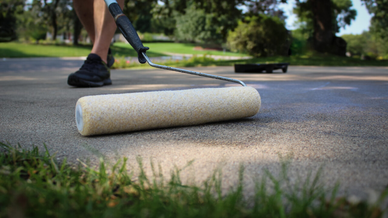 applying sealer for concrete driveway maintenance