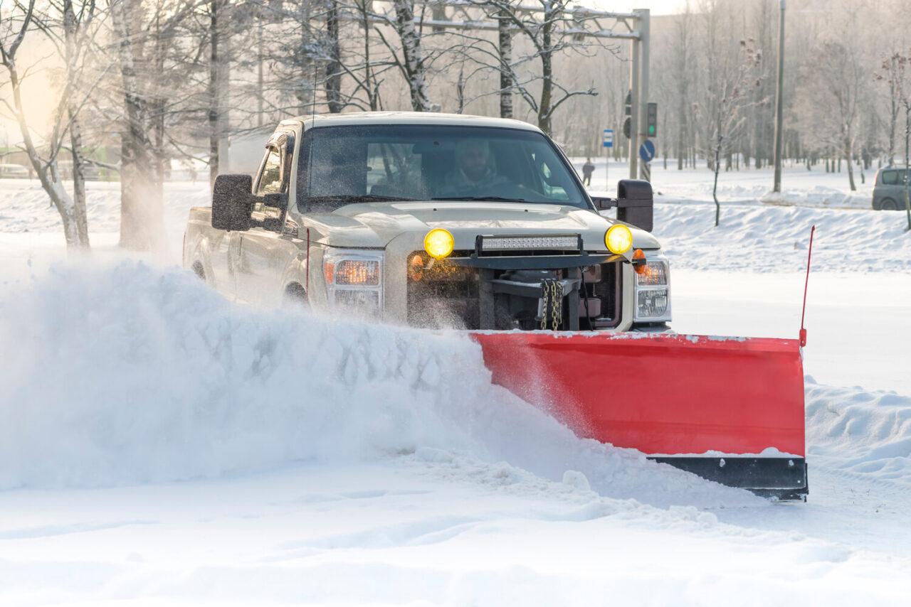snow plow with protective edge for concrete driveway maintenance