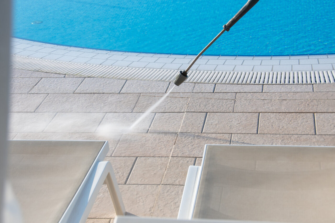 cleaning concrete pool deck with pressure washer