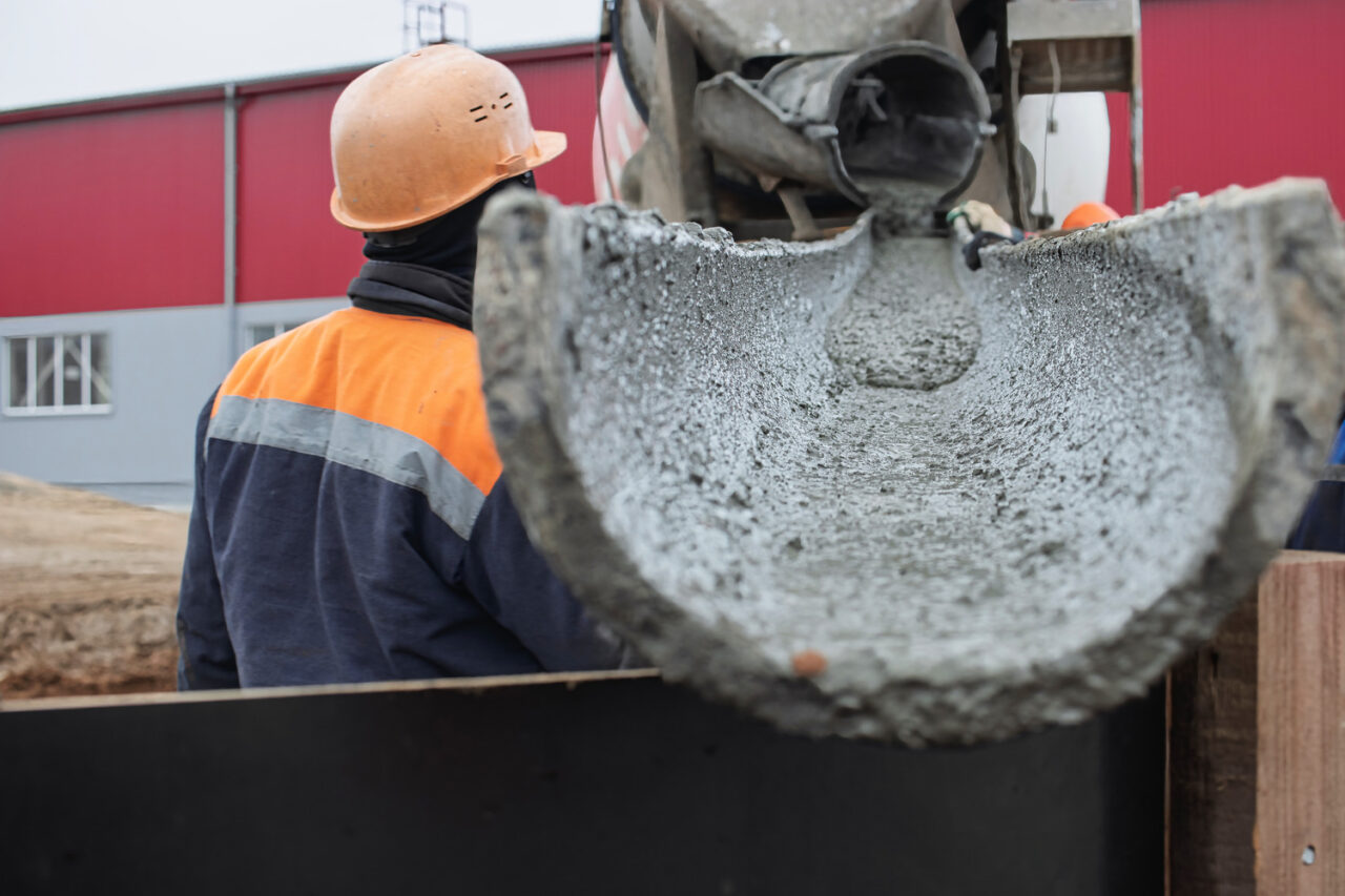 man pouring concrete in cold weather